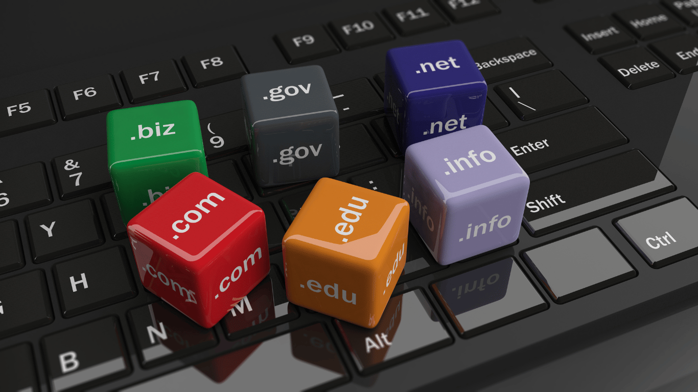 Top-level domain names on dice sitting on a keyboard.